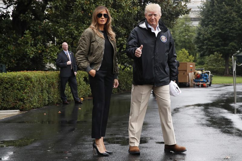 President Donald Trump, accompanied by first lady Melania Trump, gives a thumbs-up as they walk to Marine One on the South Lawn of the White House in Washington, Tuesday, Aug. 29, 2017, for a short trip to Andrews Air Force Base, Md., then onto Texas to survey the response to Hurricane Harvey. The hurricane is the first major disaster of Trump's presidency.