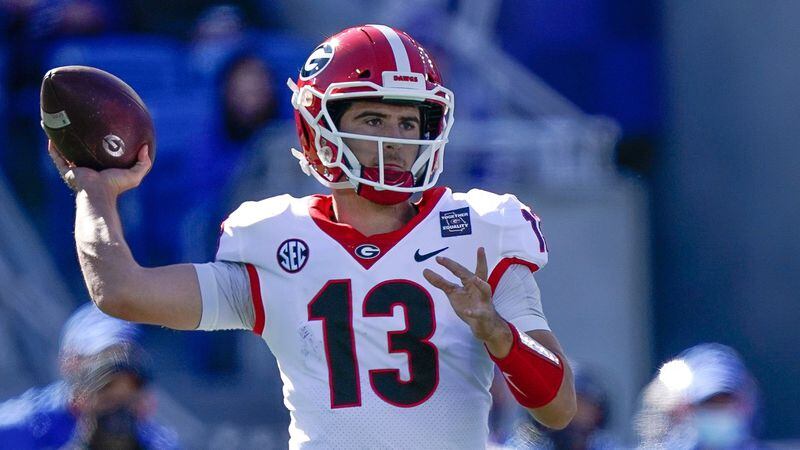 Georgia quarterback Stetson Bennett (13) passes the ball during the second half of an NCAA college football game against Kentucky, Saturday, Oct. 31, 2020, in Lexington, Ky. (AP Photo/Bryan Woolston)
