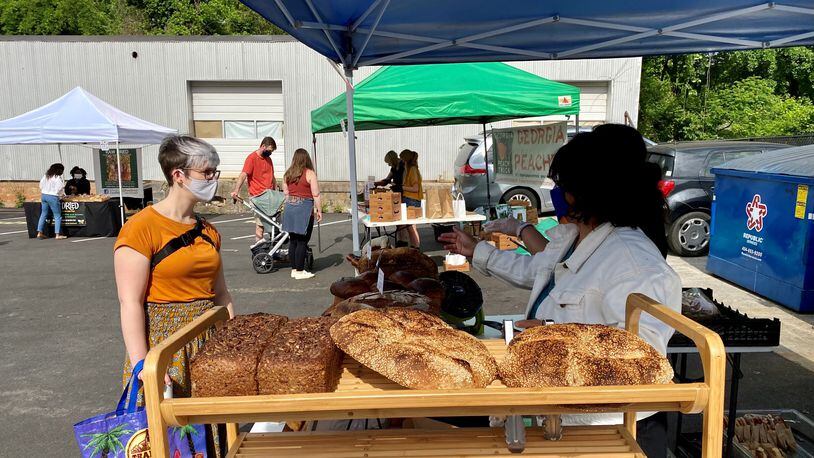 A customer places an order at Osono Bread, which pops up at Grant Park Farmers Market on Sundays. Wendell Brock for The Atlanta Journal-Constitution
