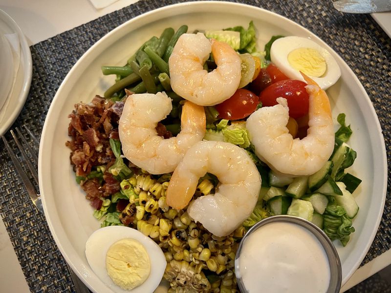 The chilled Cobb salad at Mac's Raw Bar makes use of plump, tender jumbo shrimp. Henri Hollis/henri.hollis@ajc.com