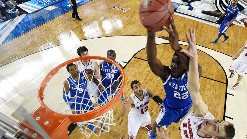during the NCAA Men's Final Four Semifinal at AT&amp;T Stadium on April 5, 2014 in Arlington, Texas. ARLINGTON, TX - APRIL 05: Alex Poythress #22 of the Kentucky Wildcats goes up for a shot as Sam Dekker #15 of the Wisconsin Badgers defends during the NCAA Men's Final Four Semifinal at AT&amp;T Stadium on April 5, 2014 in Arlington, Texas. (Photo by Chris Steppig-Pool/Getty Images)