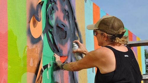Artist Linda Mitchell finishes her painting on a skatepark wall along the Atlanta Beltline. Days later, her work was ravaged by people who were not fans.