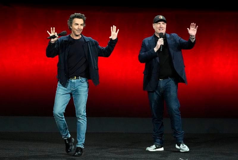 Shawn Levy, left, director of the upcoming film "Deadpool & Wolverine," and Marvel Studios president Kevin Feige wave to the audience during the Walt Disney Studios presentation at CinemaCon 2024, Thursday, April 11, 2024, at Caesars Palace in Las Vegas. (AP Photo/Chris Pizzello)