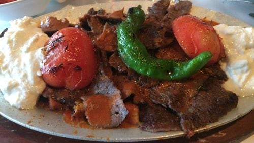 Mandolin Kitchen’s iskender is a whopping entree of sliced doner kebab meat served on a bed of pita croutons and smothered with tomato sauce. Greek yogurt is a nice accompaniment. CONTRIBUTED BY WENDELL BROCK
