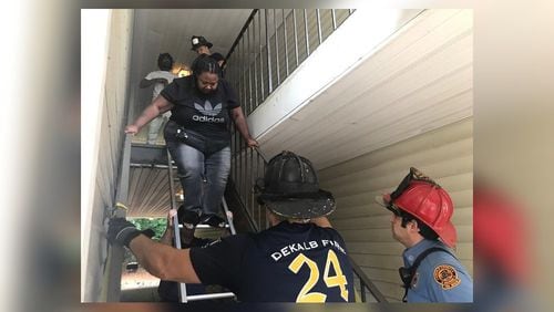DeKalb County firefighters assist residents in climbing down a ladder at Maple Walk Apartments in Decatur earlier this month. (Channel 2 Action News)