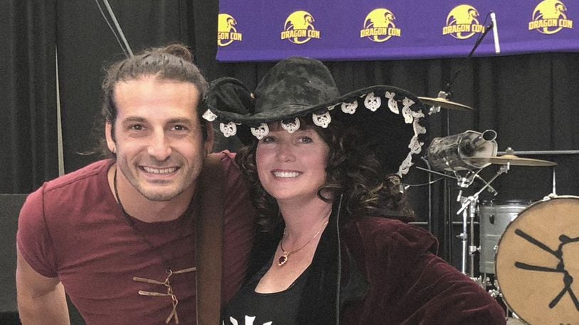 Sherrilyn Kenyon poses with a fan during last week’s Dragon Con festival, where she signed copies of “Stygian,” her latest book in the popular Dark-Hunter series. CONTRIBUTED