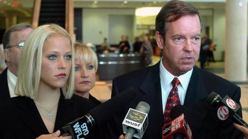 Former middle school teacher Debra Lafave, 24, left, stands with her attorney John Fitzgibbons, right, as he talks with reporters after a hearing  at the Hillsborough County Courthouse in Tampa, Fla., on July 18, 2005. Lafave, whose sexual liaisons with a 14-year-old student made tabloid headlines, broke off plea negotiations with prosecutors to claim insanity at her December trial.