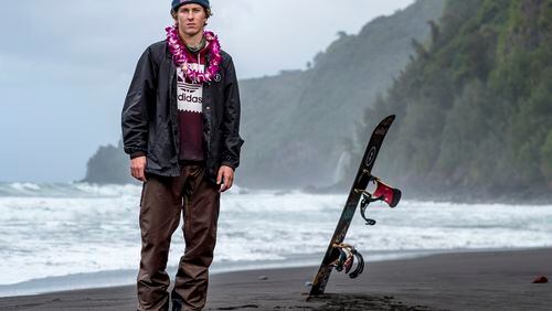 In this Feb. 21, 2017, photo provided by Red Bull, Lyon Farrell poses on a beach in Waipo Valley on the island of Hawaii. Farrell grew up skateboarding and surfing in Hawaii before a visit to New Zealand introduced him to snowboarding. Ever since, he's preferred landing triple corks to hanging 10 as he sets his sights on making the U.S. slopestyle squad for the Olympics next winter in South Korea.  (Zak Noyle/Red Bull via AP)