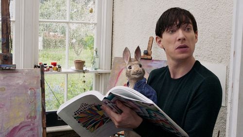 Peter Rabbit (James Corden) sits with Mr. McGregor (Domhnall Gleeson) in “Peter Rabbit.” Contributed by Sony Pictures
