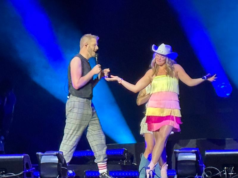 Scott Hoying of Pentatonix brings up opener Lauren Alaina to join them for Dolly Parton's "Jolene" midway through the concert at Ameris Bank Amphitheatre in Alpharetta. RODNEY HO/rho@ajc.com