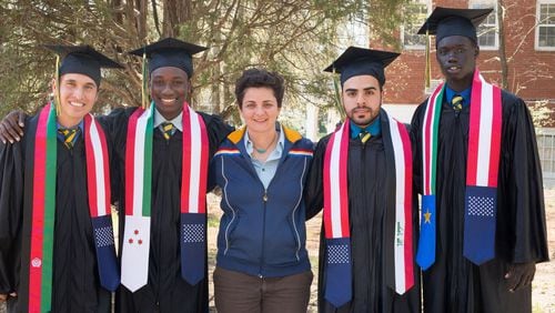 Luma Mufleh, center, with 2017 graduates of  her Fugees Academy, a private 6-12 school for refugees in Clarkston that she is now replicating in Ohio.