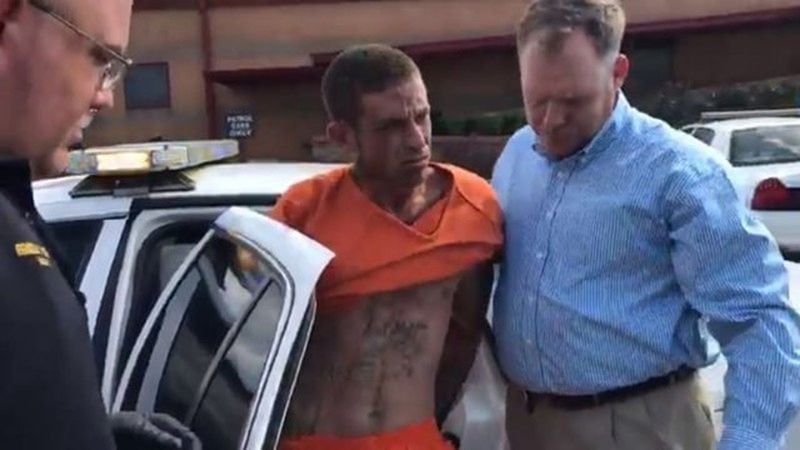 Seth Spangler is taken into custody Friday in connection with the shooting of two officers in Polk County. 