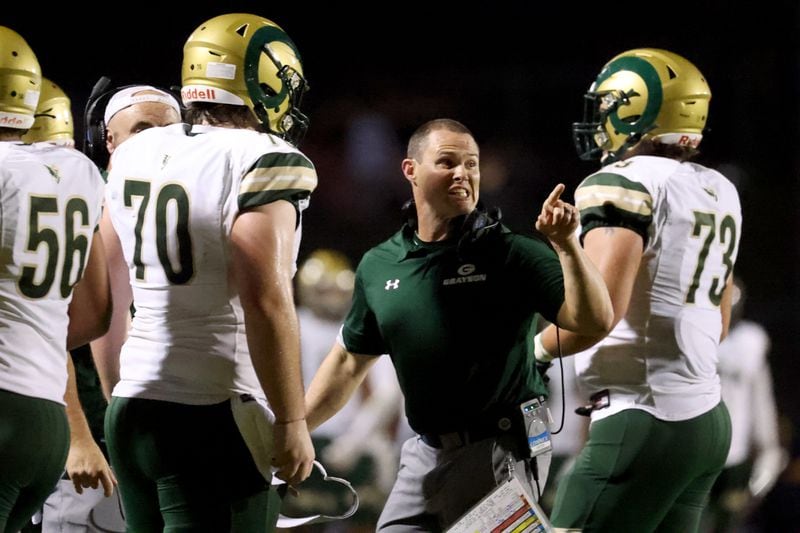Grayson head coach Adam Carter (center) reacts as he talks with offensive lineman Griffin Scroggs (70) during Friday's game.