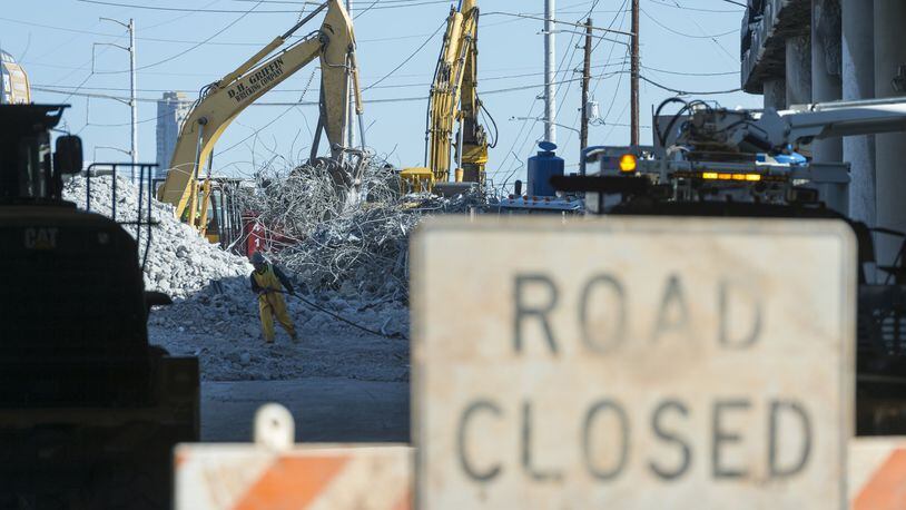 Demolition continues on Sunday on the section of I-85 that collapsed in a fire Thursday evening in Atlanta. As construction crews clear debris, traffic is stopped along northbound Piedmont Road. (DAVID BARNES / DAVID.BARNES@AJC.COM)