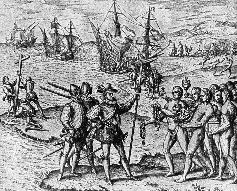 1492, Christopher Columbus (1446 - 1506) lands on Watling Island and meets the natives, while three of his shipmates erect a cross.