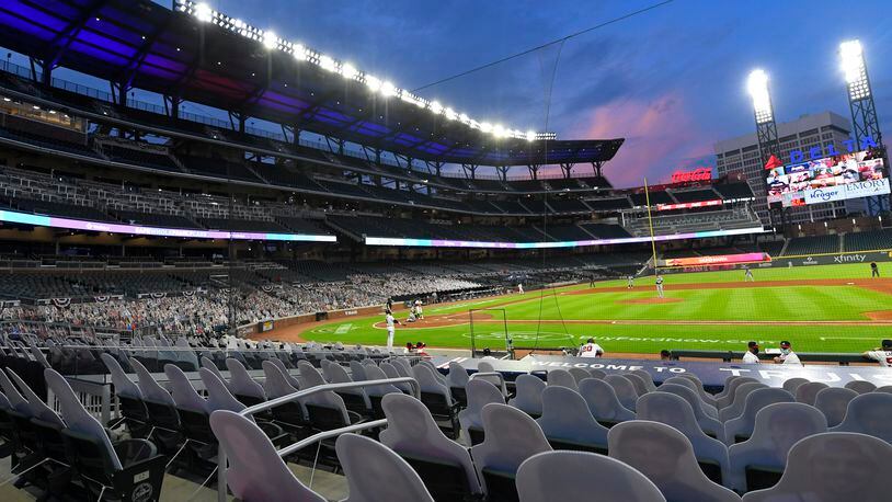 Cardboard cutouts of fans in the otherwise empty seats face the field at the Braves' Truist Park for a game against the Tampa Bay Rays, Thursday, July 30, 2020 in Atlanta.