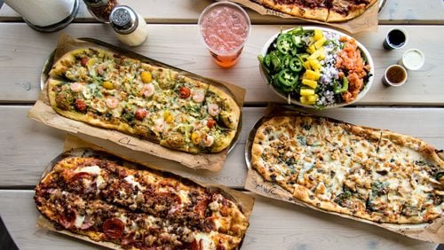 Slim and Husky's signature artisan pizzas and a Hotboy salad. Photo credit- Mia Yakel.
