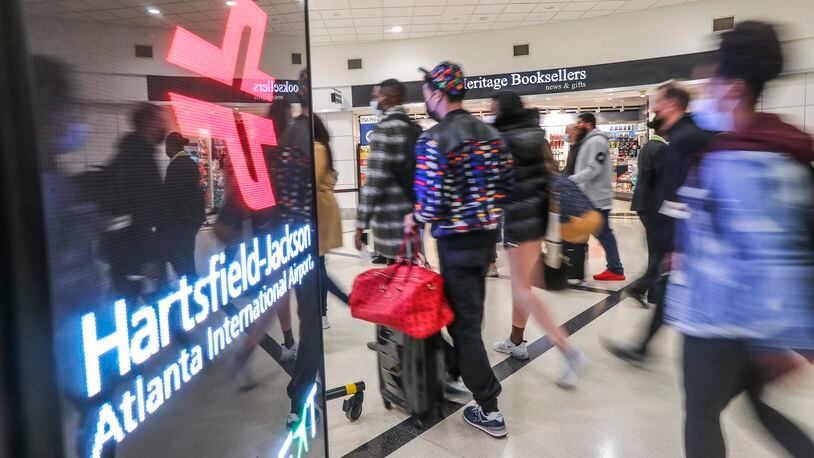 Travelers were plentiful on Friday, Nov.19, 2021, at the domestic side of Hartsfield-Jackson International Airport. On Saturday, the airport faced travel troubles after a gun discharged at a security checkpoint. (Photo: John Spink / John.Spink@ajc.com)