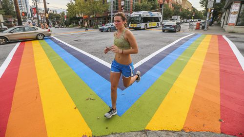 Charlotte Stephens had a brand new perspective of 10th and Piedmont Avenue in 2015. The city painted rainbow crosswalks in Midtown for the launch of Atlanta Pride that year. The colors won’t last forever. The city, citing safety concerns and state regulations, said the design cannot be permanent. JOHN SPINK /JSPINK@AJC.COM
