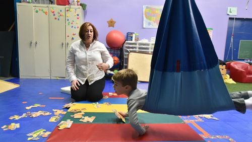 Shelley Margow, CEO of Children’s Therapy Works, works with James, 5, during a play-based therapy session at Children’s Therapy Works in Roswell earlier this month. HYOSUB SHIN / HSHIN@AJC.COM