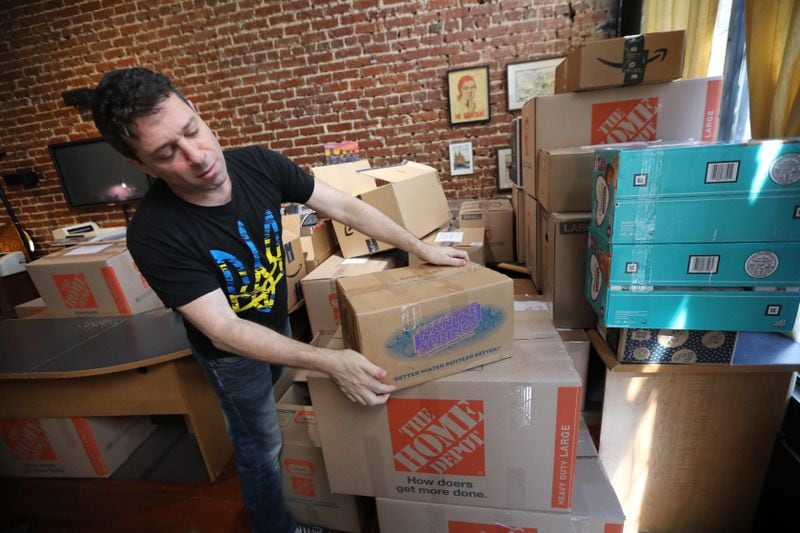 Alex Khodorkovsky organizes boxes with donated goods for Ukraine in the offices of the GotoRussia travel agency.  Miguel Martinez for The Atlanta Journal-Constitution 