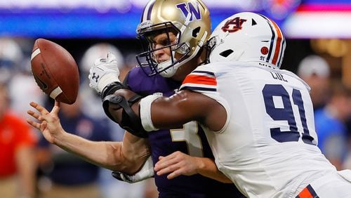 Auburn's Nick Coe arrives just in time to separate Washington quarterback Jake Browning from the ball. (Kevin C. Cox/Getty Images)