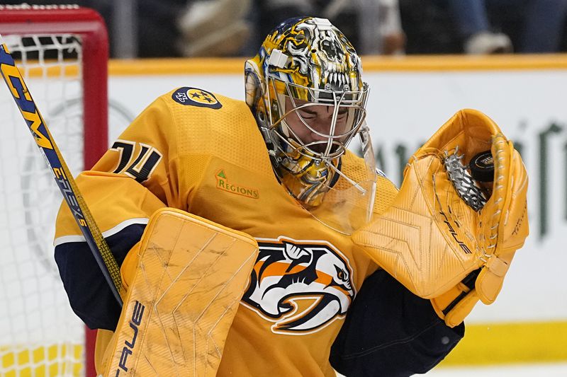Nashville Predators goaltender Juuse Saros (74) catches a puck against the Vancouver Canucks during the third period in Game 6 of an NHL hockey Stanley Cup first-round playoff series Friday, May 3, 2024, in Nashville, Tenn. The Canucks won 1-0. (AP Photo/George Walker IV)