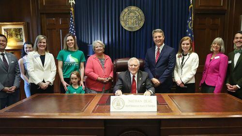 Gov. Nathan Deal signs a Brookhaven hotel motel tax increase, House Bill 575, into law on Monday, May 8, 2017. From left: Don Bolia, Jennifer Winkler, Sen. Elena Parent, Peachtree Creek Greenway Vice Chair Sarah Kennedy, Ruby Kennedy, Rep. Mary Margaret Oliver, Mayor John Ernst, Rep. Meagan Hanson, Peachtree Creek Greenway Chairwoman Betsy Eggers, Michael Diaz. Credit: Office of the Governor.