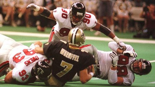 Atlanta defensive end Chuck Smith (90) assists teammates Dan Owens (93) and Travis Hall (98) in bringing down Saints quarterback Danny Wuerffel during the Falcons 23-17 win at the Louisiana Superdome in New Orleans on Sunday Oct. 12, 1997.