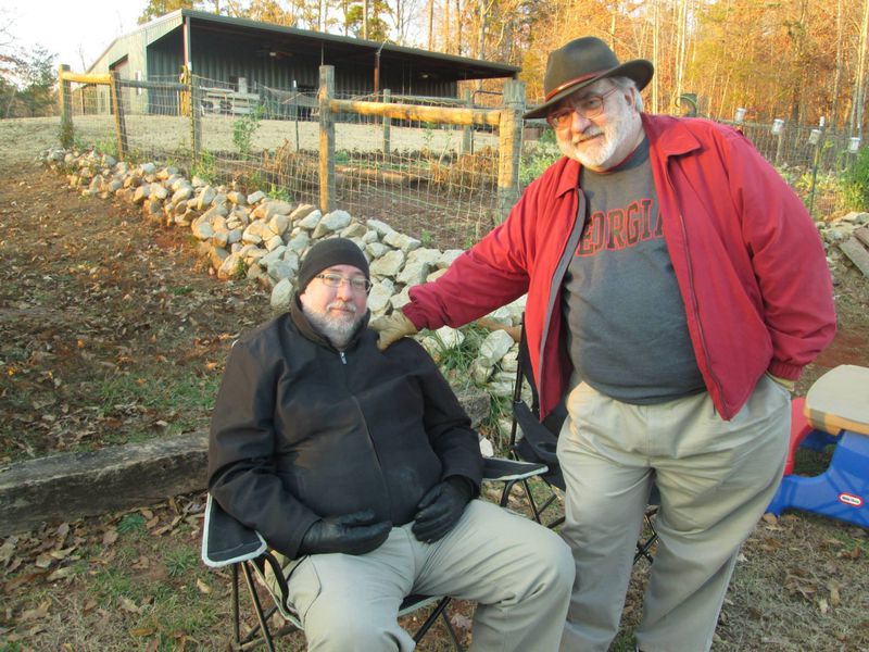 Bill King (right) and his brother Tim await the Thanksgiving bonfire at Blackberry Farmstead, near Toccoa. CONTRIBUTED BY OLIVIA KING