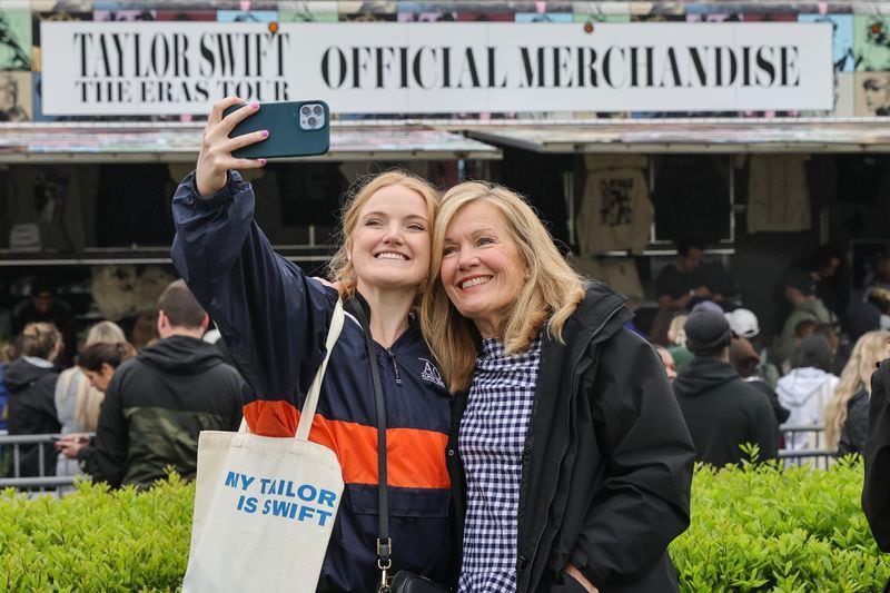 (Left to right) Savannah Sipsey and her mother Vickie take a selfie outside of Mercedes Benz Stadium while waiting in line to purchase Taylor Swift merchandise on Thursday, April 27, 2023. (Natrice Miller/natrice.miller@ajc.com)