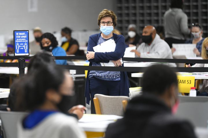 An observer monitors as votes for President are recounted at the Gwinnett County elections office on Friday, Nov.13, 2020 in Lawrenceville. (JOHN AMIS FOR THE ATLANTA JOURNAL-CONSTITUTION)