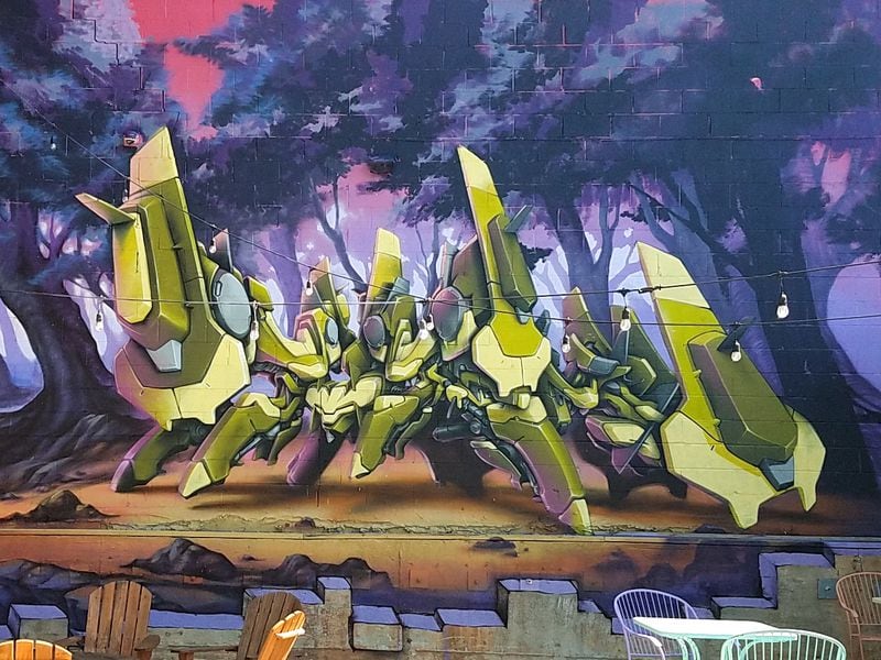 The wall facing the Beltline includes one of Mr. Totem’s iconic Tactical Dreadnought Lettermech pieces.