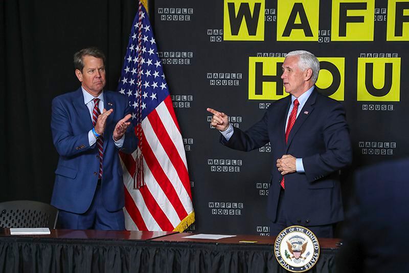 Gov. Brian Kemp (left) applauds Vice President Mike Pence after his remarks at the roundtable discussion at the Waffle House corporate offices in Norcross on Friday, May 22, 2020. (Photo: JOHN SPINK/JSPINK@AJC.COM)