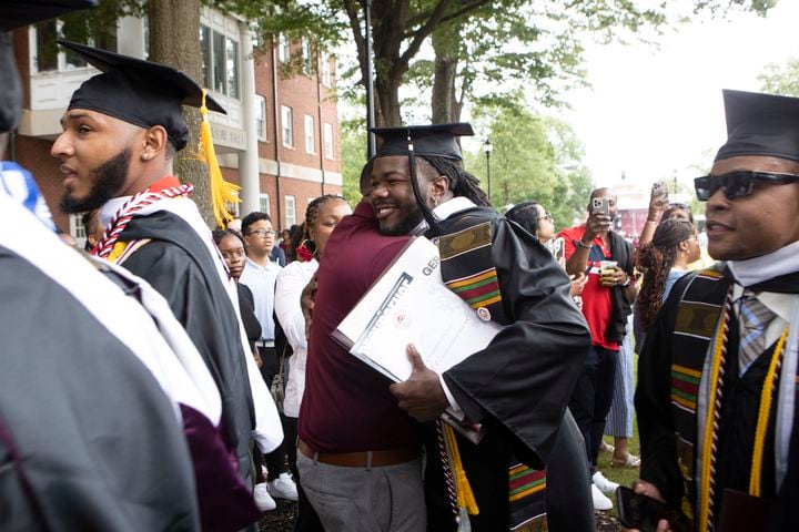 A Morehouse College graduate embraces a family member after the Morehouse College commencement ceremony on Sunday, May 21, 2023, on Century Campus in Atlanta. The graduation marked Morehouse College's 139th commencement program. CHRISTINA MATACOTTA FOR THE ATLANTA JOURNAL-CONSTITUTION