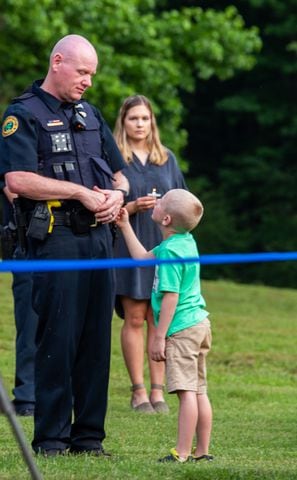 The Holly Springs community and neighboring police departments and their families gather at Barrett Park for a candlelight vigil for Holly Springs Police Officer Joe Burson on Friday, June 18, 2021 after he was killed during a traffic stop earlier this week.  (Jenni Girtman for The Atlanta Journal-Constitution)