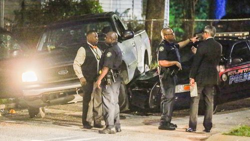 Atlanta police investigators were on the scene of a chase that ended in a shooting on Fri., Aug. 21, 2015. JOHN SPINK / JSPINK@AJC.COM