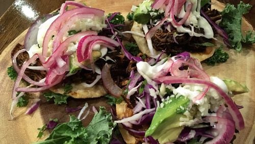 The chicken mole tostadas at Patria Cocina are garnished with pickled red onions, sour cream, cotija cheese and avocado. CONTRIBUTED BY WYATT WILLIAMS