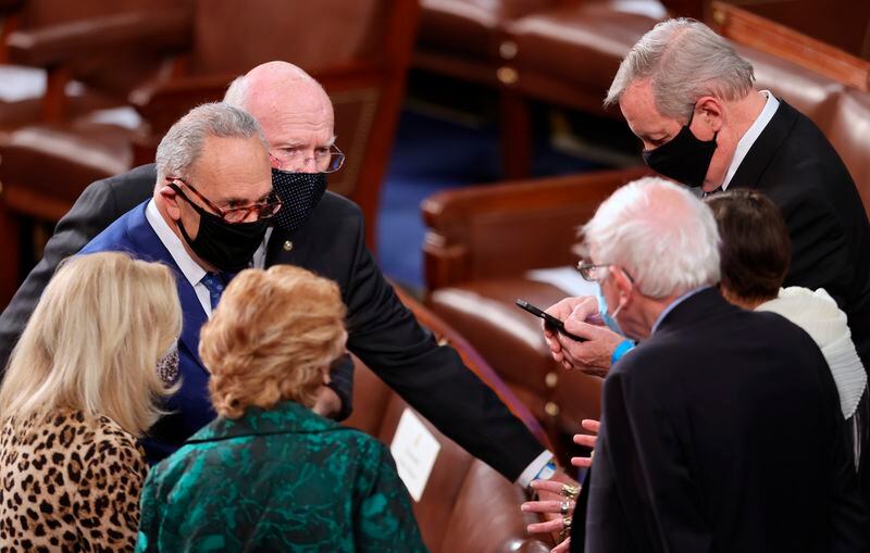 FILE - Senate Majority Leader Chuck Schumer, D-N.Y., talks with Sen. Patrick Leahy, D-Vt., Sen. Dick Durbin, D-Ill., Sen. Bernie Sanders, I-Vt., and other members of Congress before President Joe Biden arrives to deliver his first address to a joint session of the U.S. Congress inside the House Chamber of the U.S. Capitol in Washington, on April 28, 2021. (Jonathan Ernst/Pool via AP)