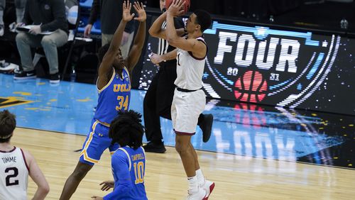 Gonzaga guard Jalen Suggs (1) shoots over UCLA guard David Singleton (34) to win the game during overtime in a men's Final Four NCAA college basketball tournament semifinal game, Saturday, April 3, 2021, at Lucas Oil Stadium in Indianapolis. Gonzaga won 93-90. (AP Photo/Darron Cummings)