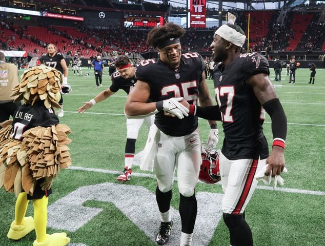 Atlanta Falcons running back Tyler Allgeier (25) and safety Richie Grant (27) celebrate after winning a NFL football game against the New Orleans Saints 24-15 in Atlanta on Sunday, Nov. 26, 2023.   (Bob Andres for the Atlanta Journal Constitution)