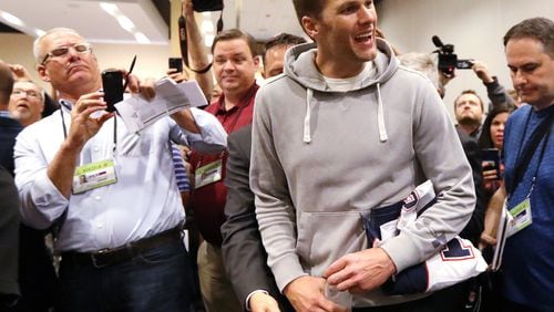 Patriots quarterback Tom Brady arrives for interviews with his jersey under his arm during Super Bowl media availability at the JW Marriott Galleria on Wednesday, Feb. 1, 2017, in Houston. (Curtis Compton/ccompton@ajc.com)