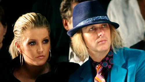 ** FILE ** In this Sept. 10, 2007 file photo, Lisa Marie Presley and her husband Michael Lockwood watch the Anna Sui 2008 spring/summer show at Fashion Week in New York. (AP Photo/Seth Wenig, file)