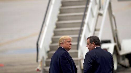 Donald Trump and New Jersey Gov. Chris Christie return to Trump's jet after a campaign event at Port Columbus International Airport in Columbus, Ohio, March 1, 2016. Christie says he first met Trump 14 years ago as a courtesy to Judge Maryanne Trump Barry, after she told him, “My little brother really wants to meet you.”
