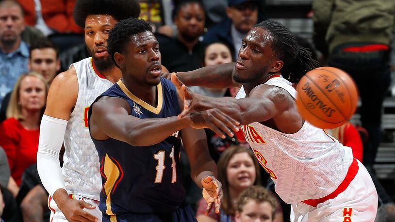 Jrue Holiday of the New Orleans Pelicans passes the ball against Taurean Prince (right) and DeAndre Bembry of the Atlanta Hawks at Philips Arena on November 22, 2016 in Atlanta, Georgia. (Photo by Kevin C. Cox/Getty Images)