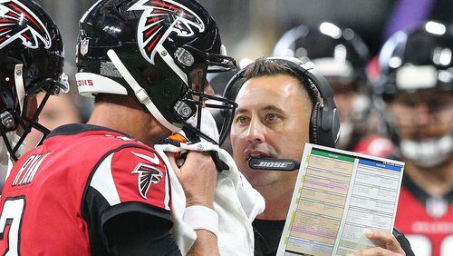 Falcons offensive coordinator Steve Sarkisian confers with Matt Ryan during the first half against the Panthers Sunday, Sept 16, 2018, in Atlanta.