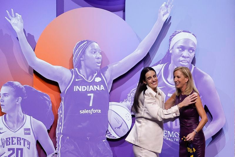 Iowa's Caitlyn Clark greets WNBA commissioner Cathy Engelbert after being selected first overall by the Indiana Fever during the first round of the WNBA basketball draft, Monday, April 15, 2024, in New York. (AP Photo/Adam Hunger)