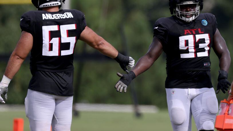 Falcons defensive lineman Abdullah Anderson (65) greets defensive lineman Timothy Horne during training camp. Horne, an undrafted rookie free agent from Kansas State, was the unsung hero of the 27-23 win over the Lions on Friday. (Jason Getz / Jason.Getz@ajc.com)