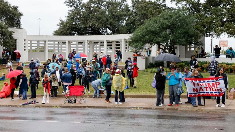 QAnon supporters gather along Elm Street at Dealey Plaza in downtown Dallas on Tuesday. The group believes John F. Kennedy Jr., who died in a plane crash in 1999, will return and reinstate Donald Trump as president.