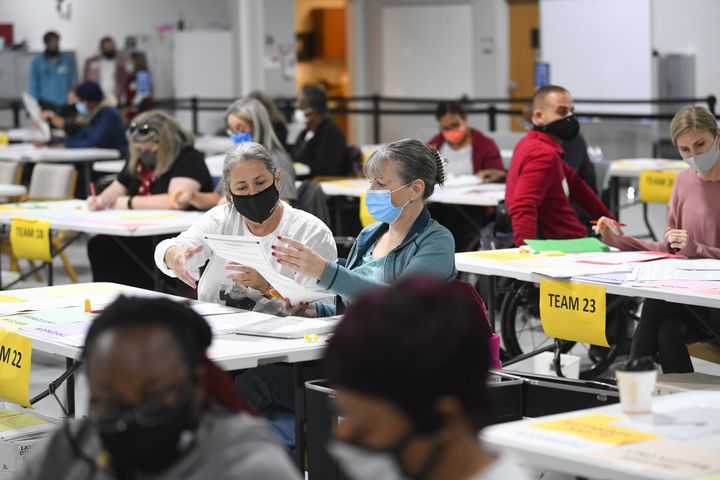 Election workers look over ballots as votes for President are recounted at the Gwinnett County elections office on Friday, Nov.13, 2020 in Lawrenceville. (JOHN AMIS FOR THE ATLANTA JOURNAL-CONSTITUTION)